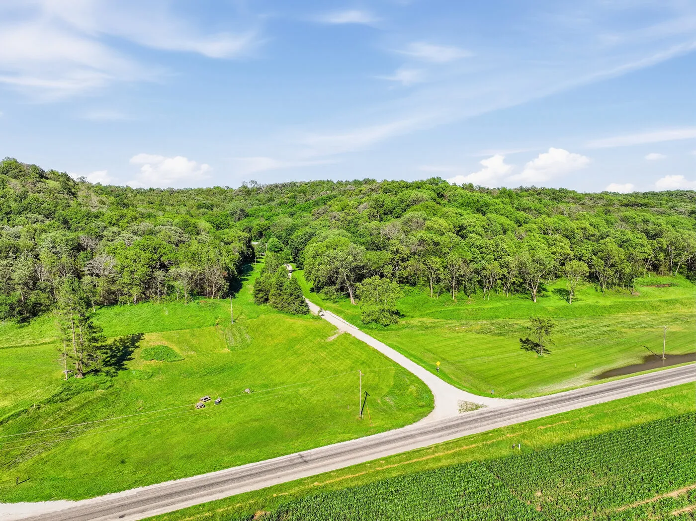 Country road winding through the green timber and pasture at Glacier Ridge